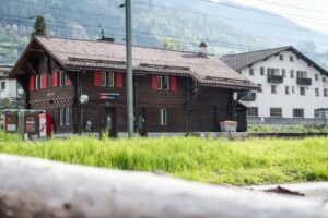 Gruppenhaus Sample House in City of Sample, hölzernes Haus vor einem Grasfeld