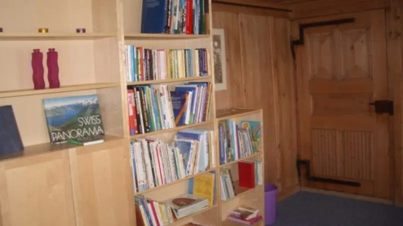 Gruppenunterkunft Haus Alpenblick Schwarzenegg - Holz Bücherregal im Zimmer