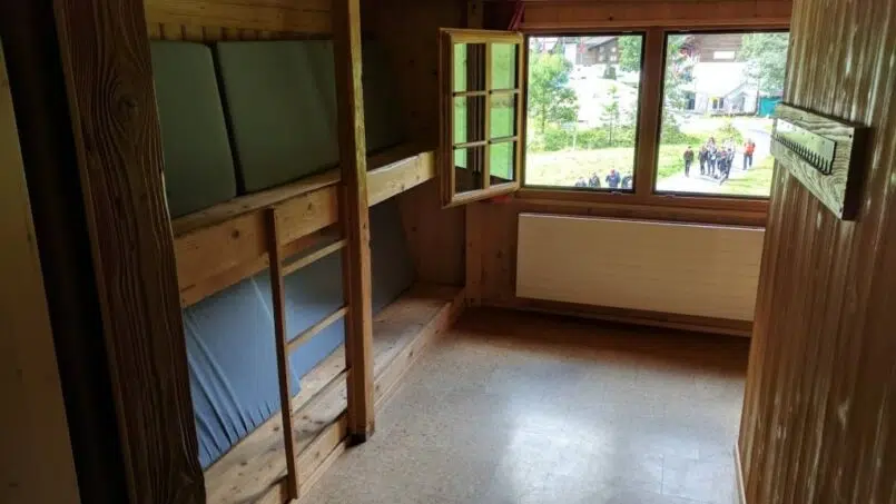 Gruppenunterkunft Cevi Haus Kandersteg: Zimmer mit Etagenbetten und Fenster.