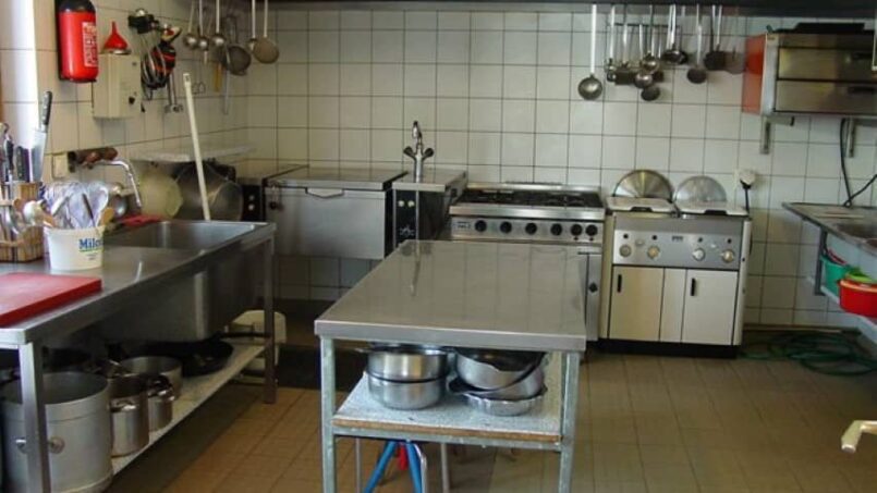 Küche im Chalet Bel-Oiseau Gruppenunterkunft in La Lécherette mit vielen Töpfen und Pfannen