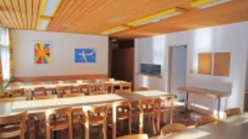Gruppenunterkunft Haus Christkath Giswil - Klassenzimmer mit Holztischen und Stühlen