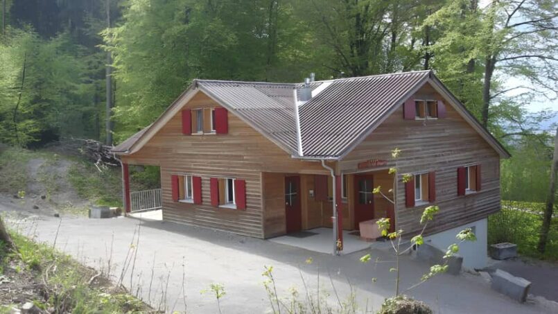 Gruppenunterkunft Jungwachtferienhaus Klingenzell in Eschenz mit roten Fensterläden im Waldgebiet