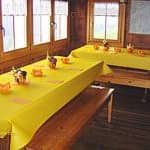 Gruppenhaus Ebnat-Kappel - Ski- und Clubhaus Pfungen Innenausstattung gelbes Tischtuch auf Holztisch